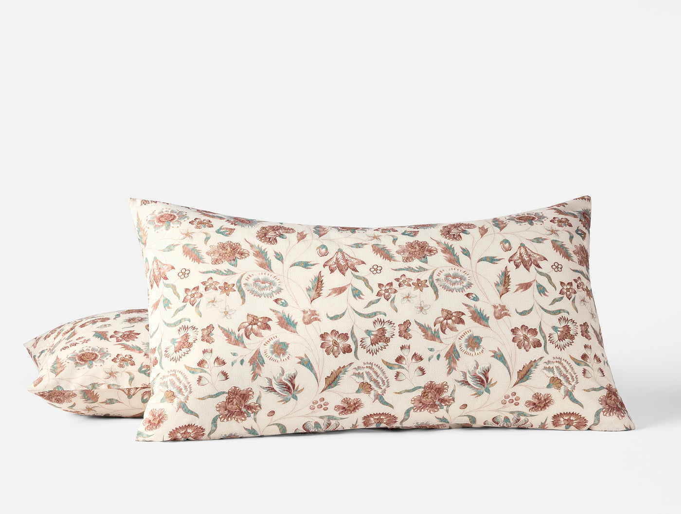Pair of Coyuchi Viola Print shams showing floral botanical pattern in terracotta and sage on ivory.