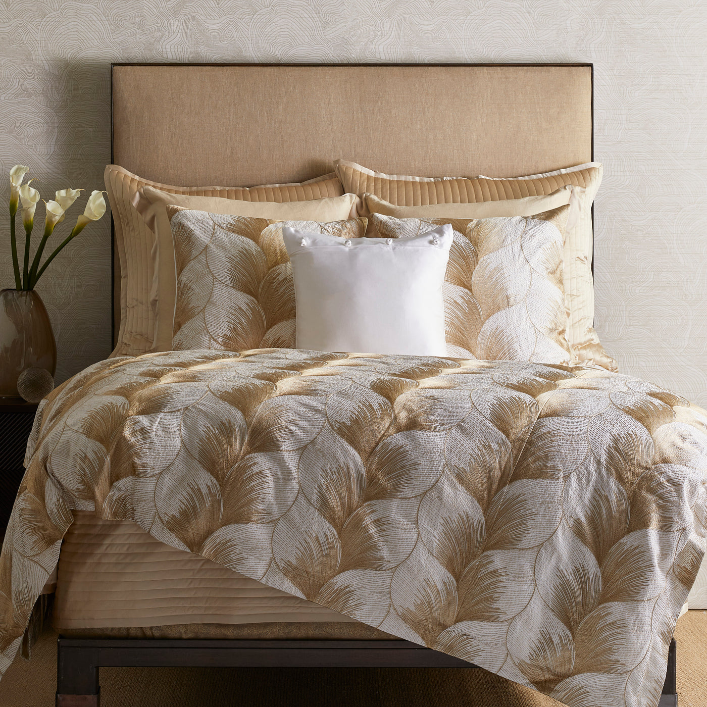 Champagne and ivory fan-motif duvet cover with layered leaf pattern, styled on a made bed.