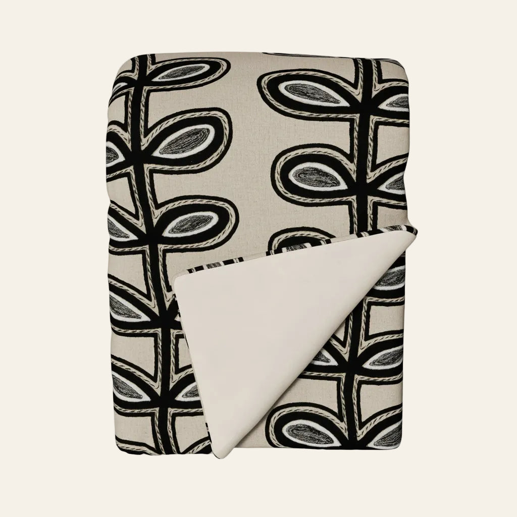 Ann Gish Fellini throw, ivory and black graphic leaf print, folded to show solid ivory reverse.