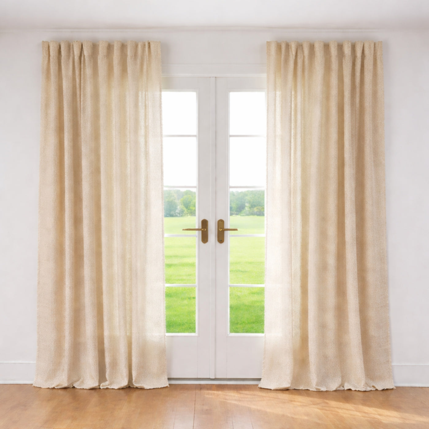 Ann Gish Ficelle curtain panels in champagne linen, floor-length, flanking a sunlit French door.