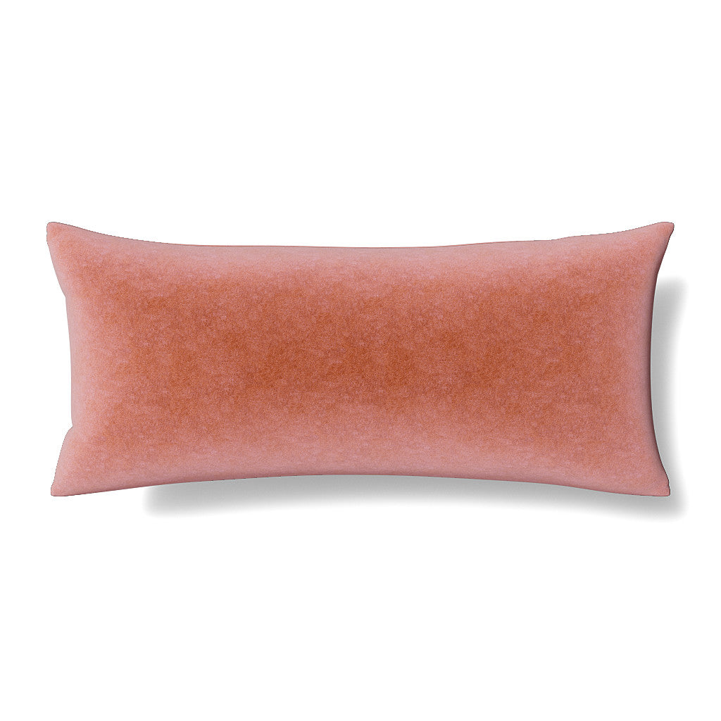 Elongated lumbar pillow in dusty rose velvet with subtle texture, shown on white background.