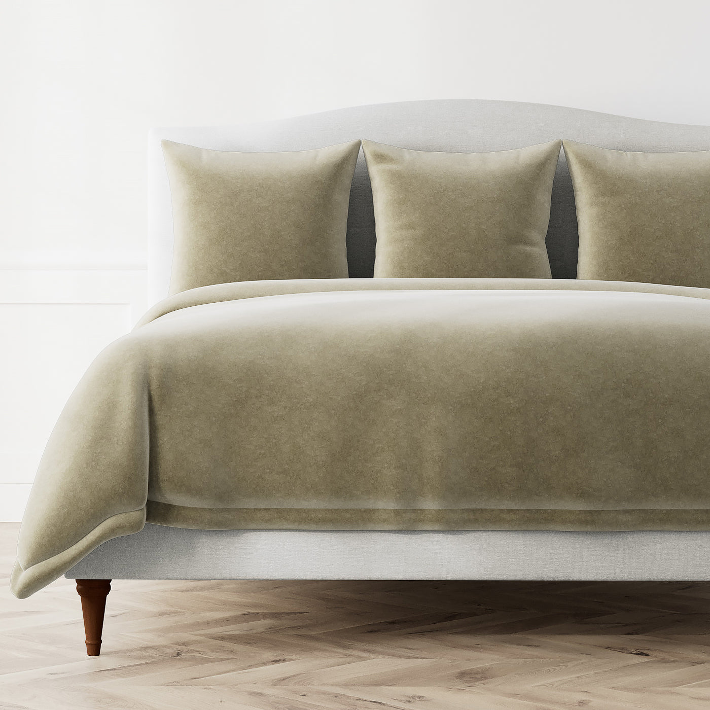 Ann Gish Fresco Velvet duvet cover in sage green styled on a bed with matching shams.