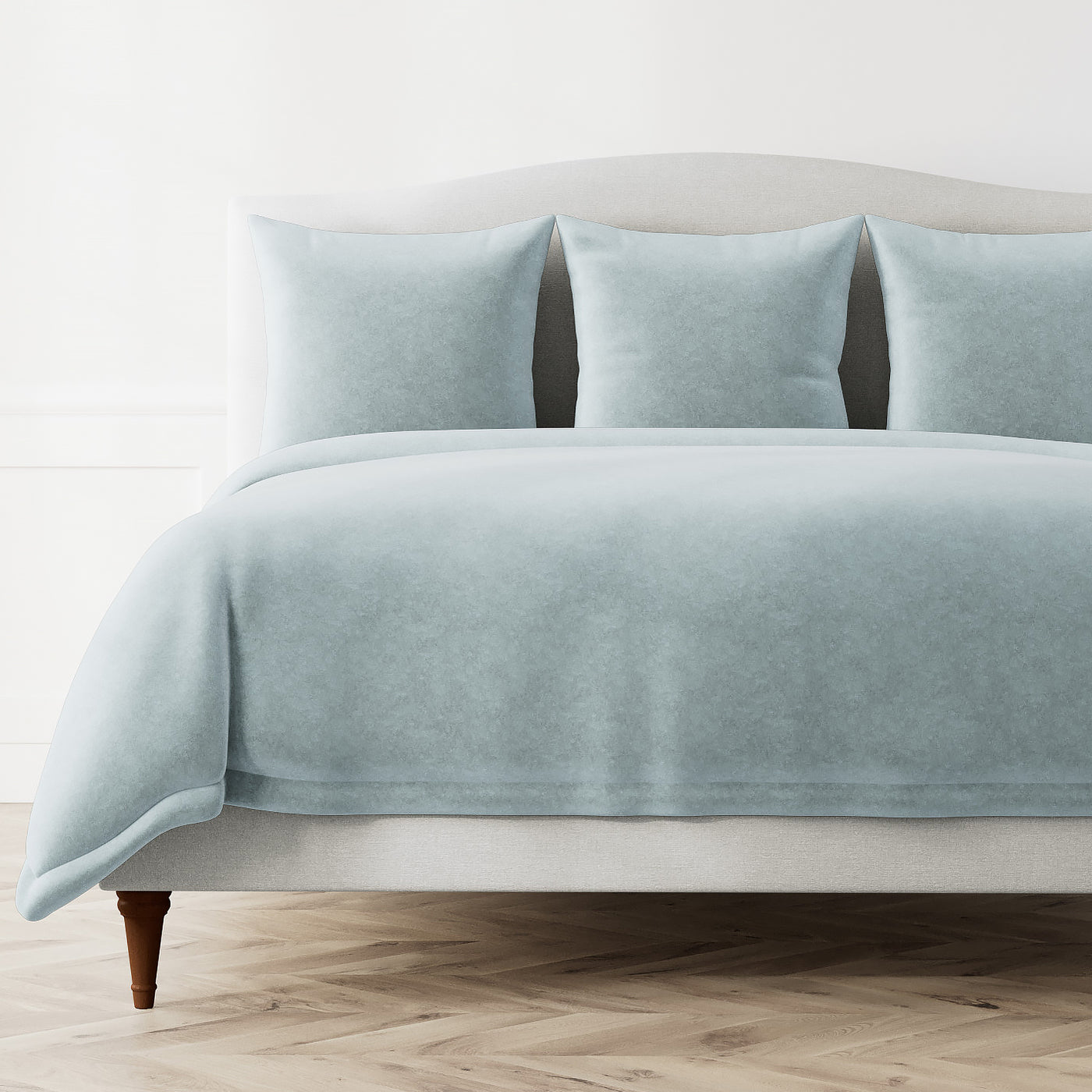 Ann Gish Fresco Velvet duvet cover in pale blue styled on a made bed with matching shams.