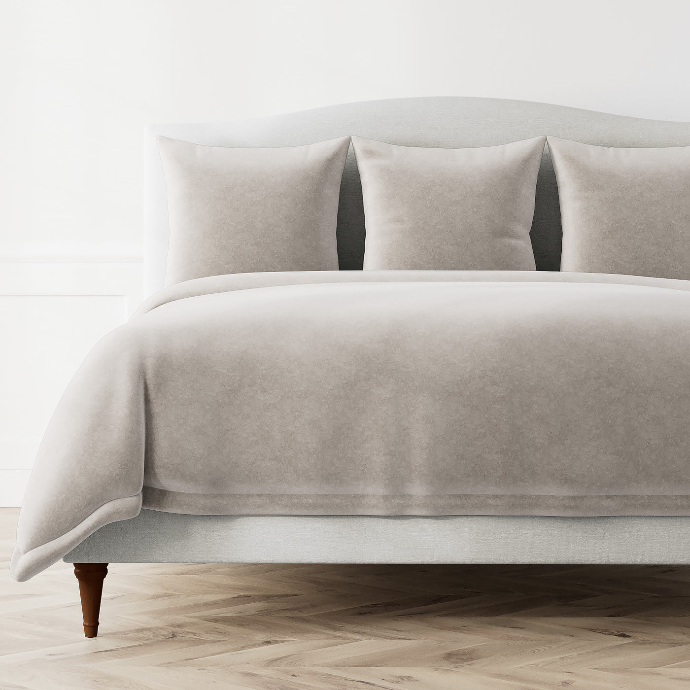 Fresco Velvet duvet cover and shams in silver-taupe styled on a bed, herringbone floor.