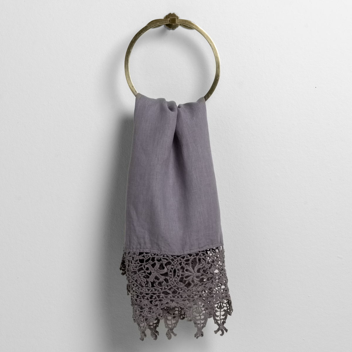 Frida guest towel in French Lavender draped on brass ring, showing intricate crochet lace hem detail.