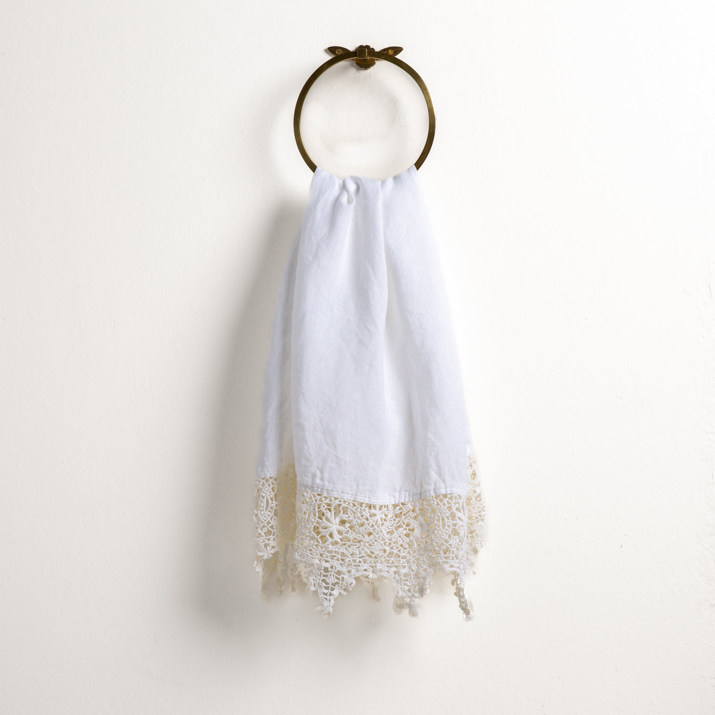 Bella Notte Frida guest towel in White with ivory crochet lace trim, hung on brass ring.