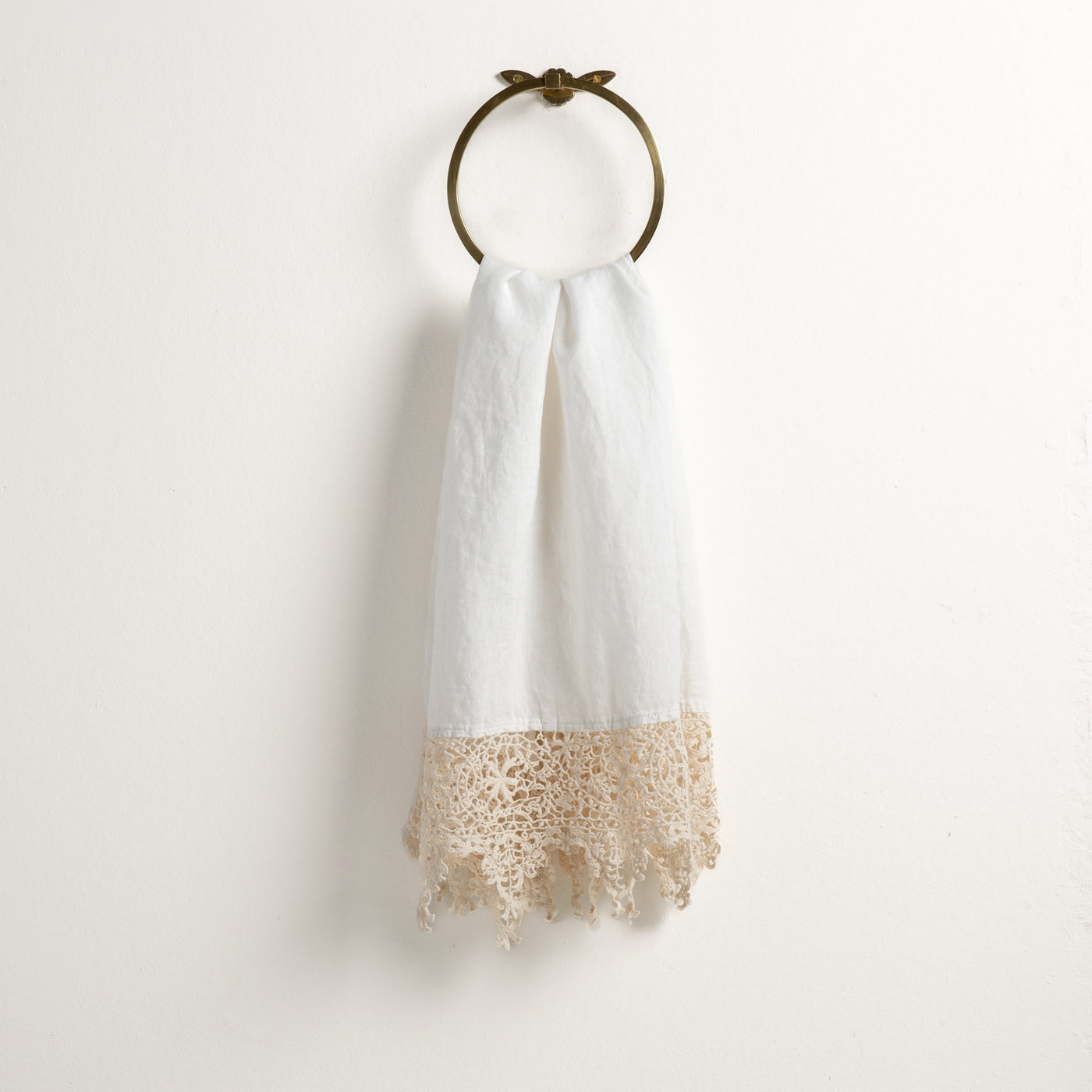 Bella Notte Frida guest towel in Winter White, detailed lace hem trim, hung on brass ring.