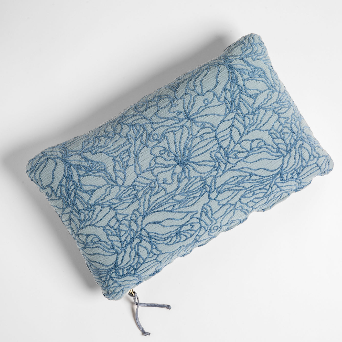 Bella Notte Georgia throw pillow in Tahoe Blue, floral outline embroidery, zipper detail visible.