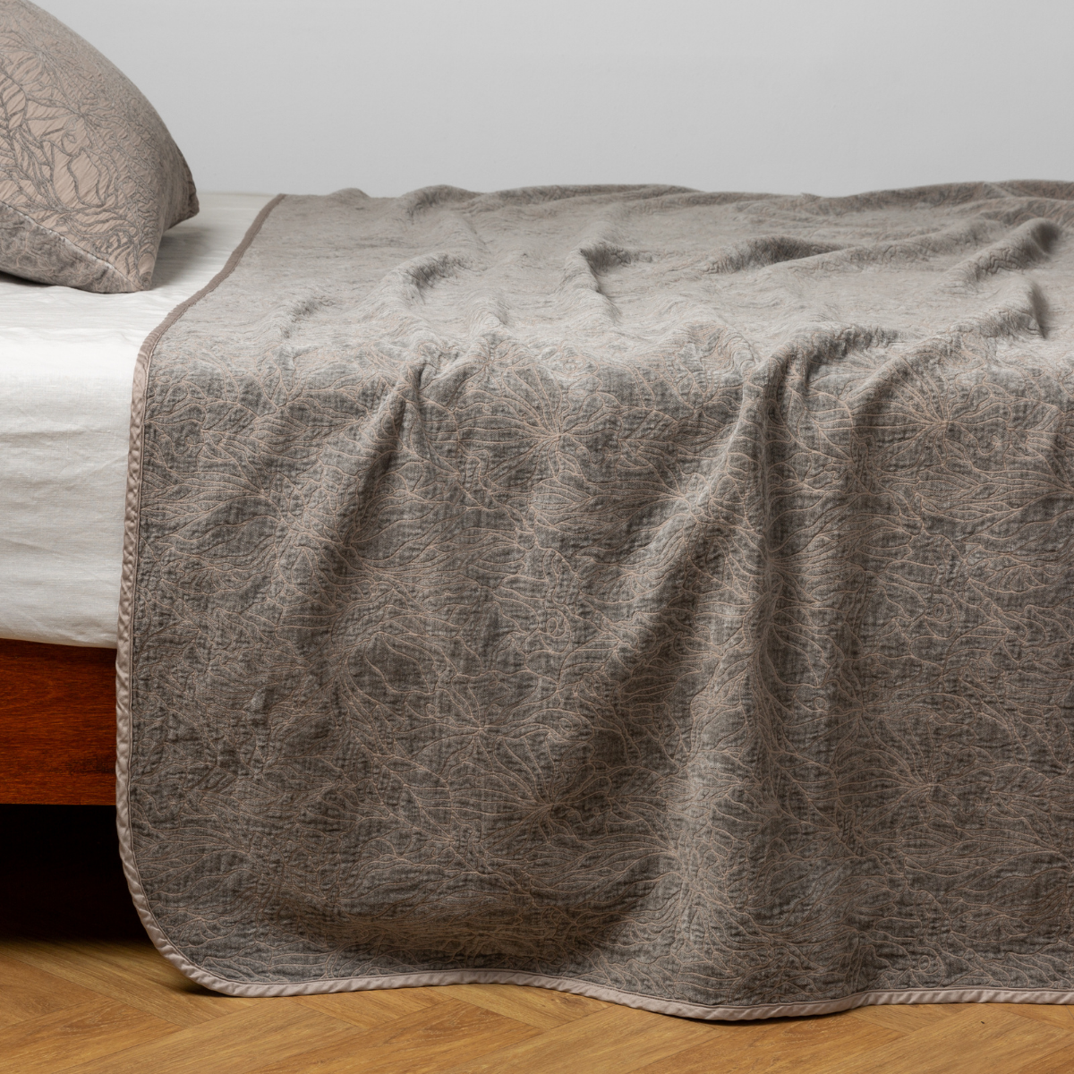Fog Georgia bedspread draped over bed corner, showing scalloped trim detail.