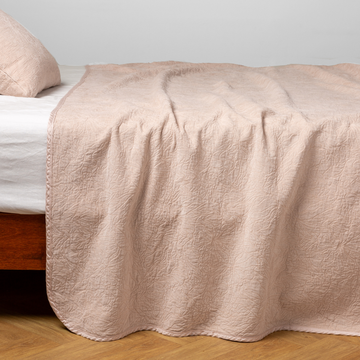 Bella Notte Georgia bedspread in Pearl draped over bed, showing full coverage and quilted texture.