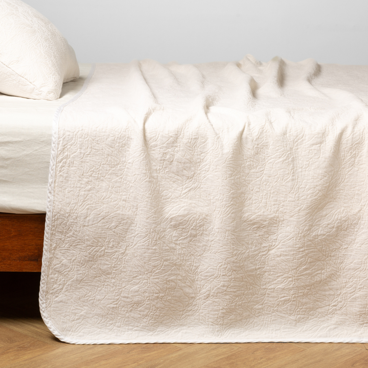 Bella Notte Georgia bedspread in Winter White, draped over a bed with soft texture detail.