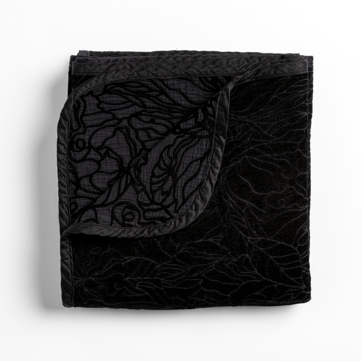 Corner fold detail revealing Bella Notte Georgia blanket's floral velvet texture in Corvino.