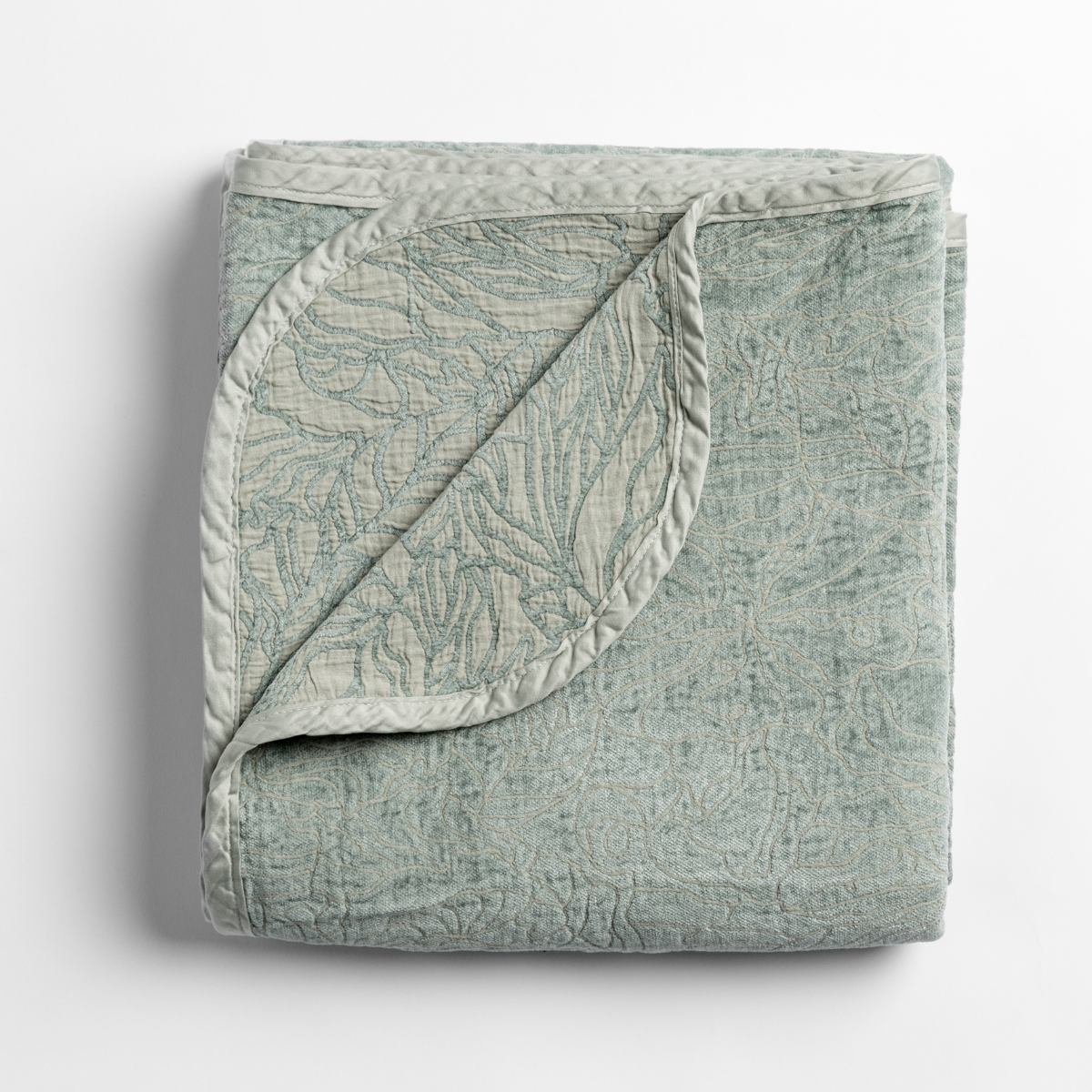 Corner fold detail of Bella Notte Georgia blanket in Eucalyptus, showing quilted botanical pattern.