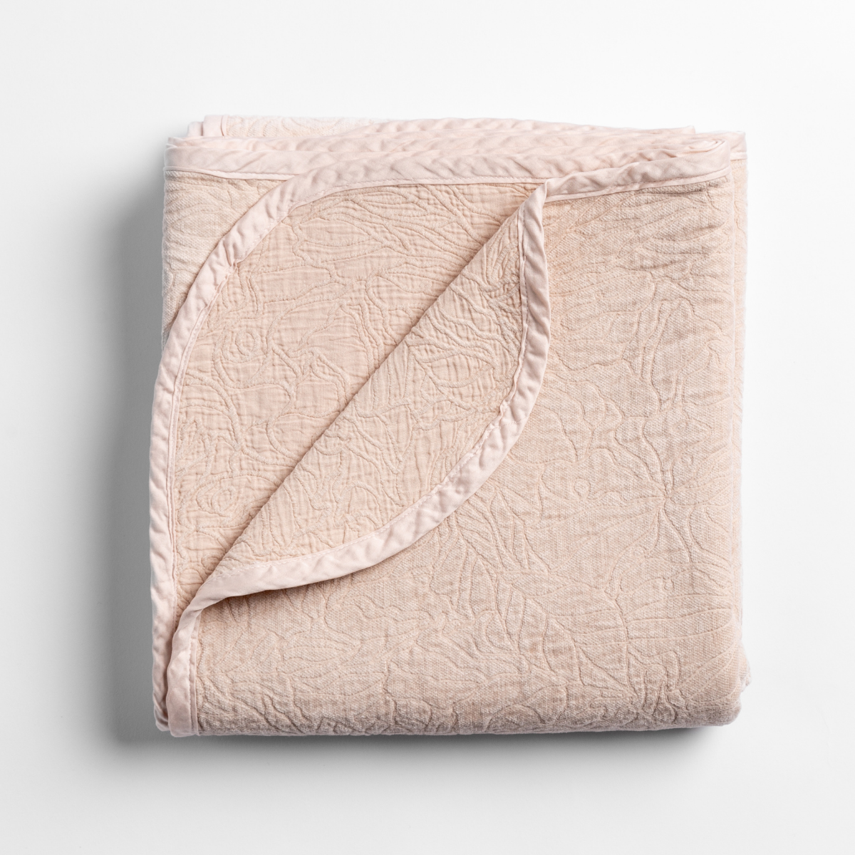 Bella Notte Georgia blanket in Pearl, folded to show satin trim and matelassé texture.