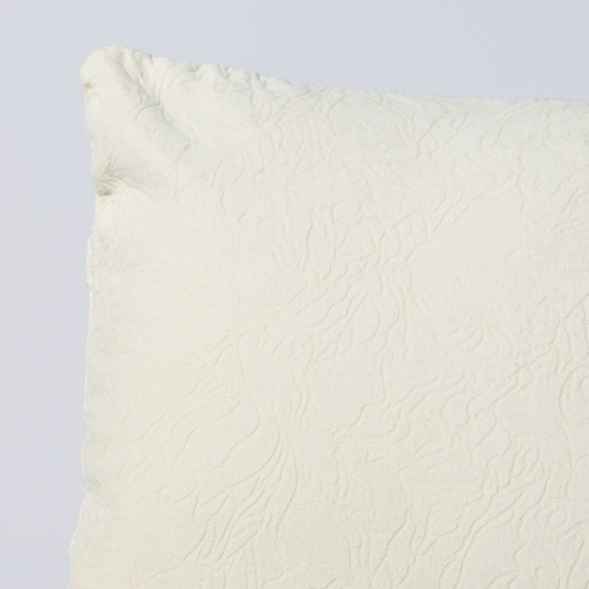Close-up of Natural Georgia throw pillow corner showing embossed floral quilted texture.