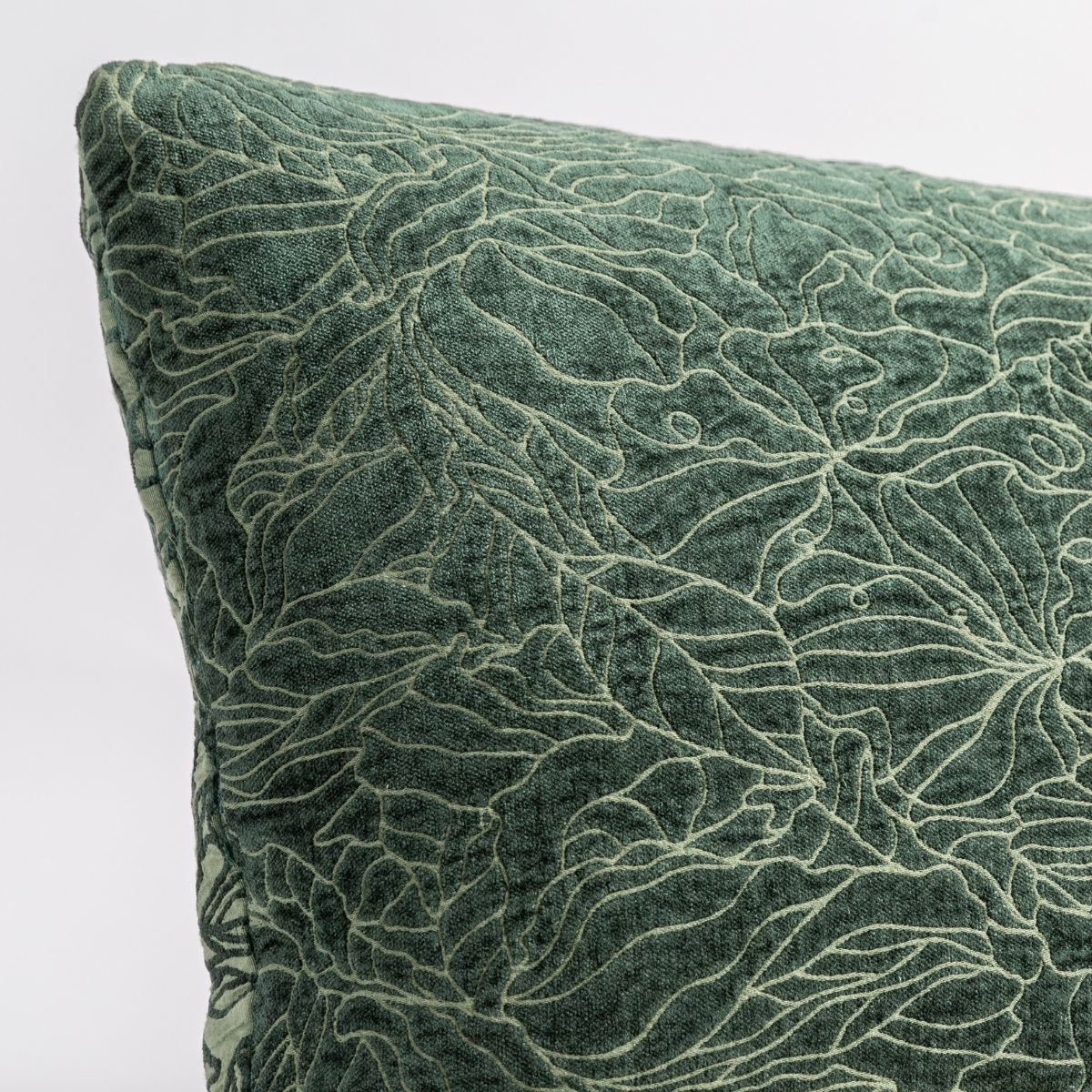Close-up of Juniper velvet throw pillow corner with tonal leaf pattern in raised texture.
