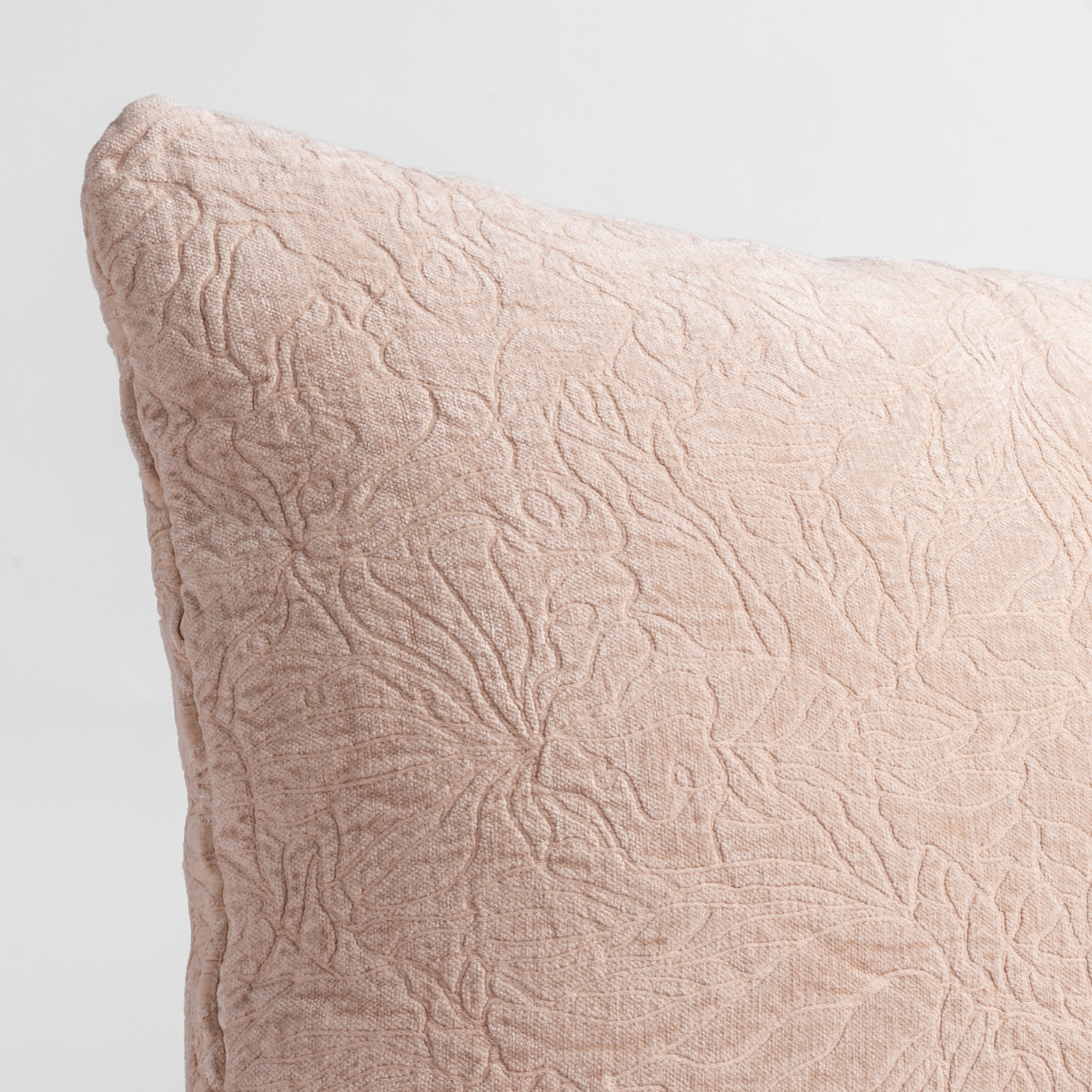 Close-up of Pearl Georgia sham corner with embossed floral quilted texture.