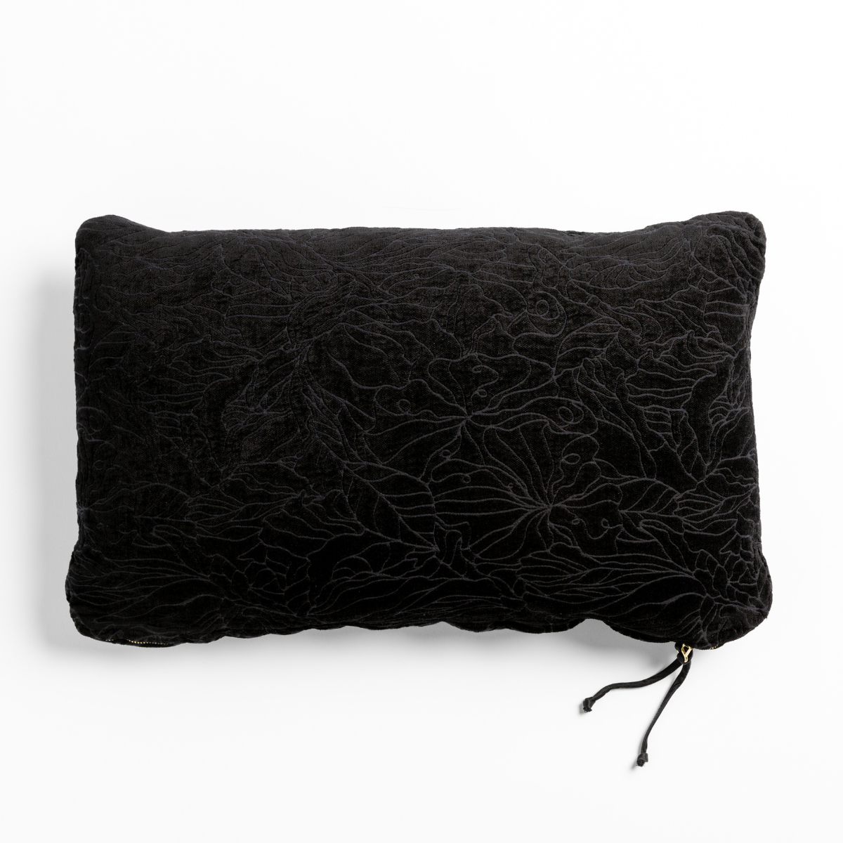 Corvino velvet throw pillow with embossed floral pattern and tassel detail, back view.