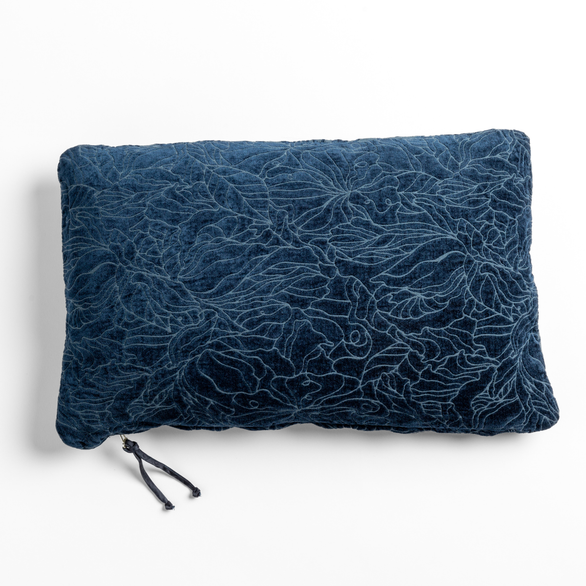 Midnight velvet throw pillow with tonal floral embroidery and tassel zipper detail.