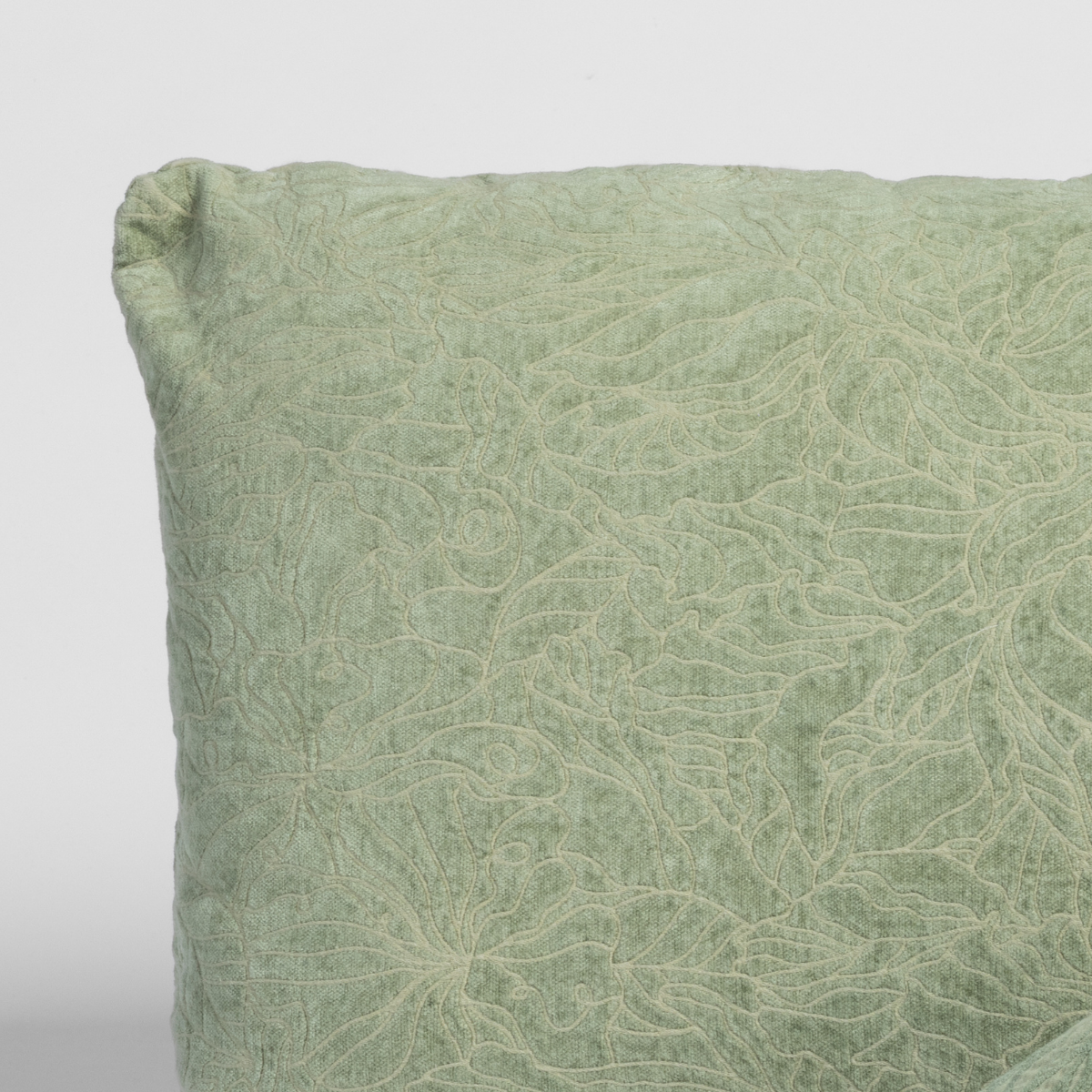 Close-up of Desert Sage sham corner showing tonal floral embroidery on textured linen fabric.