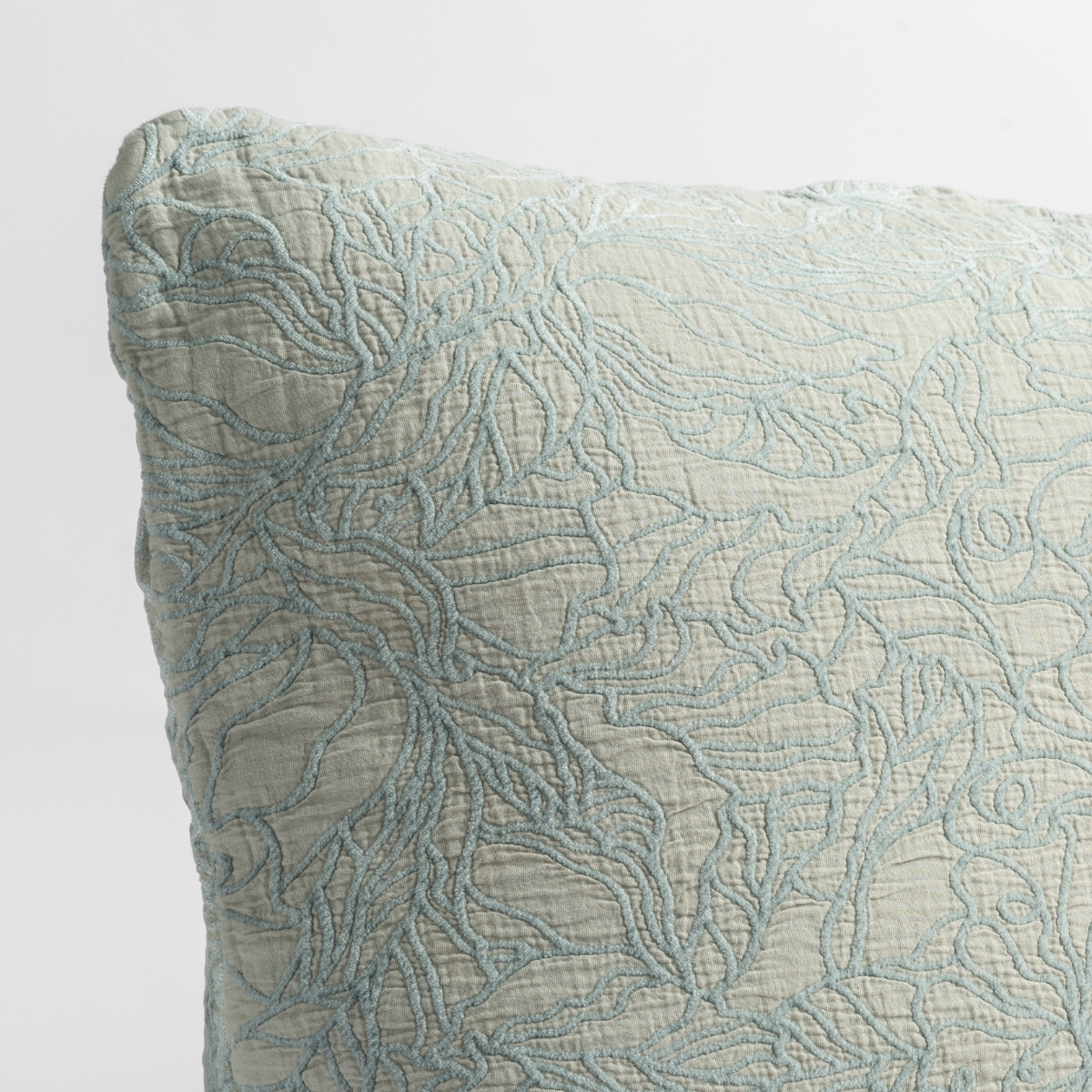 Close-up of Cloud Georgia sham corner showing delicate swirling embroidery texture.
