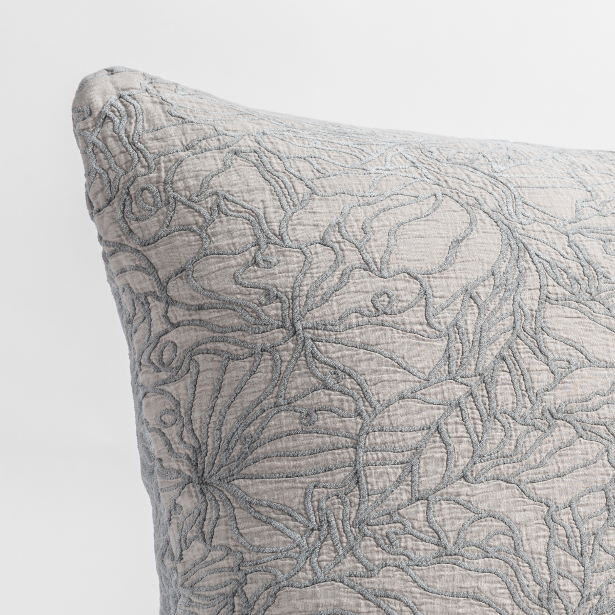 Close-up of Bella Notte Georgia sham corner in Fog with floral quilted embroidery detail.