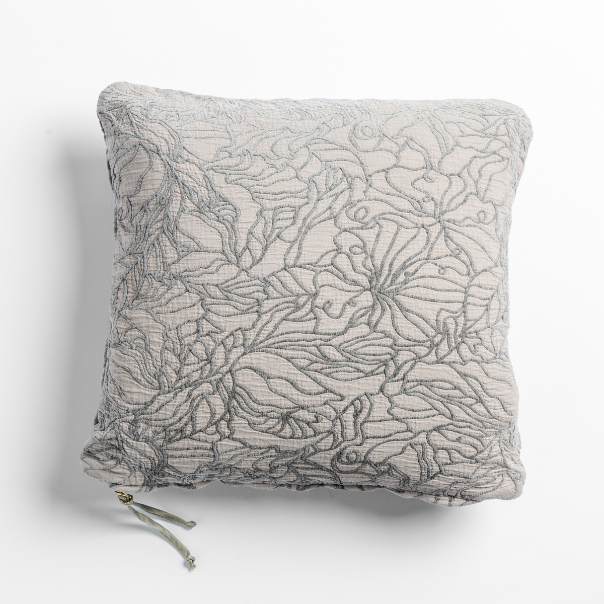 Fog Georgia throw pillow close-up showing allover floral embroidery texture and tassel detail.