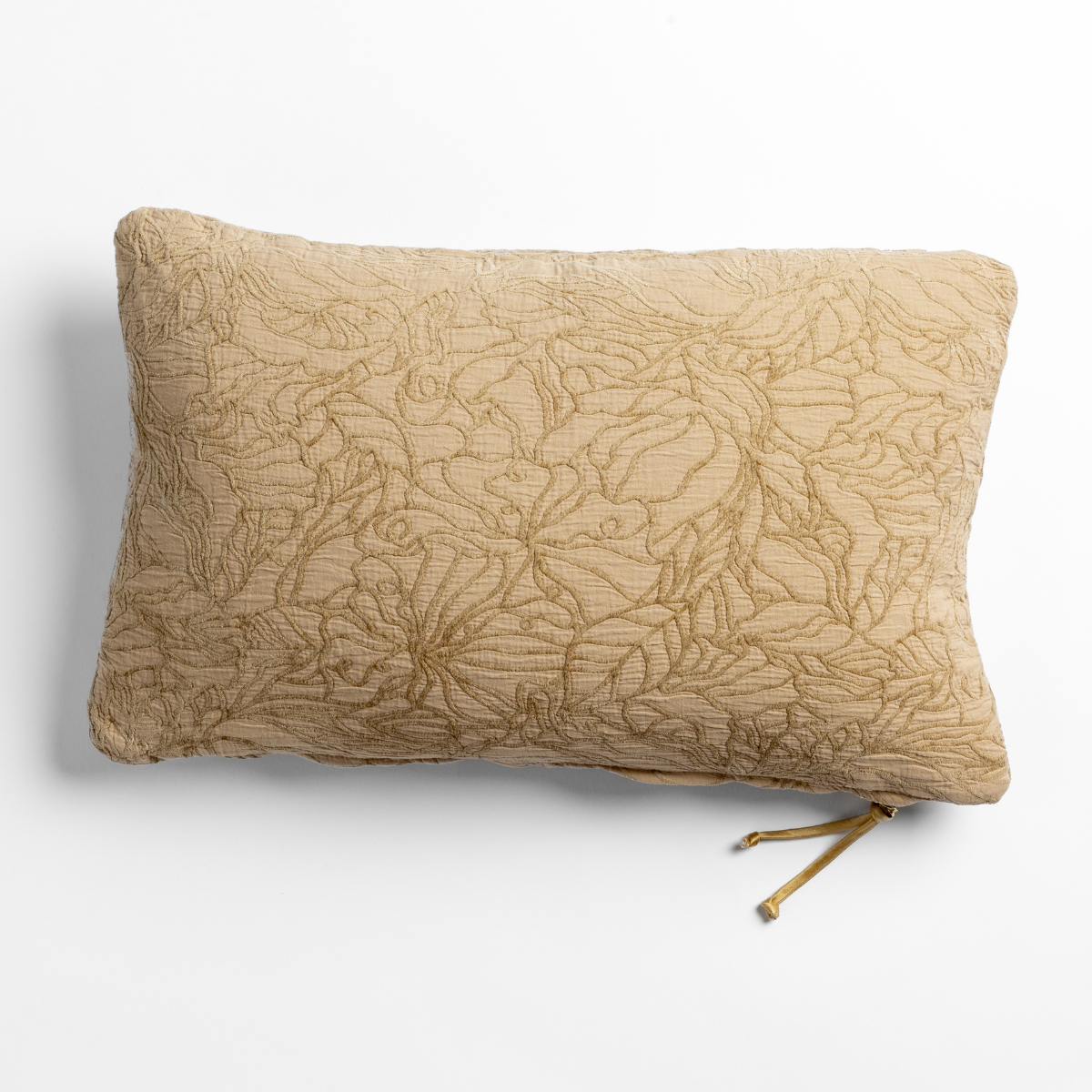 Honeycomb Georgia throw pillow with allover floral embroidery and tassel tie detail.