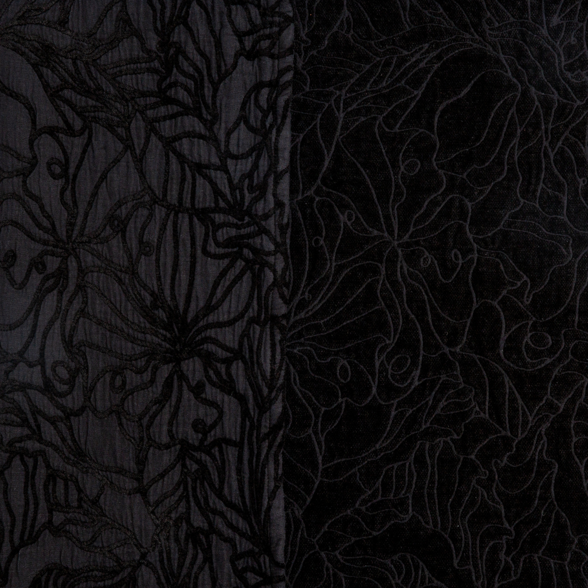Close-up of Bella Notte Georgia sham in Corvino, showing floral embroidery on two fabric textures side by side.