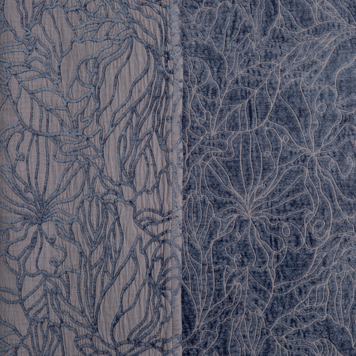 Close-up of French Lavender Georgia bedspread showing floral embroidery detail on both fabric sides.