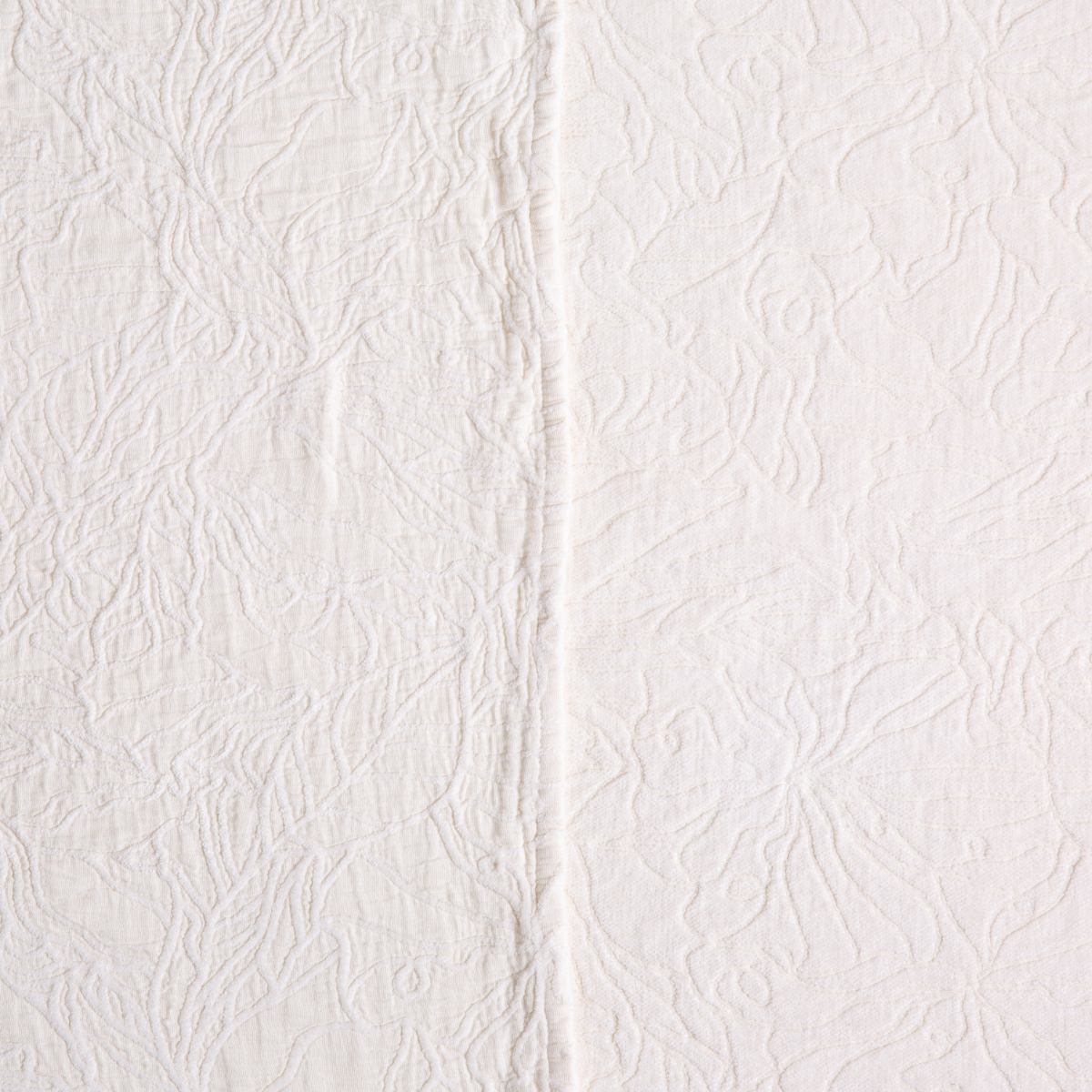 Close-up of Winter White matelassé floral texture with center seam detail.