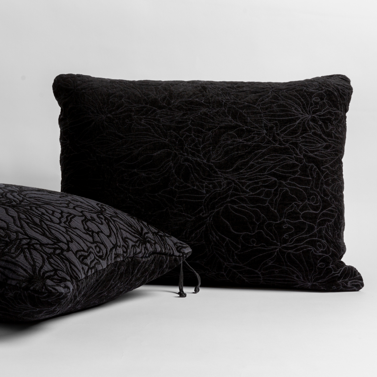 Two Bella Notte Georgia shams in Corvino, showing floral embroidery texture and tassel detail.