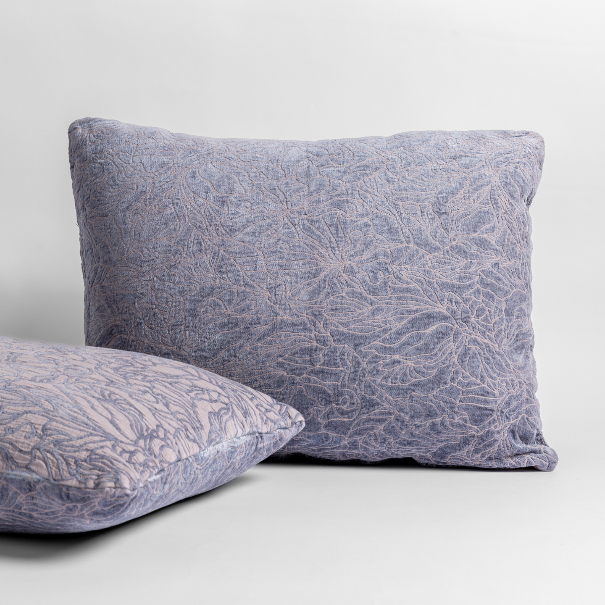 Two Bella Notte Georgia shams in French Lavender, showing crinkled floral texture from front and side angles.