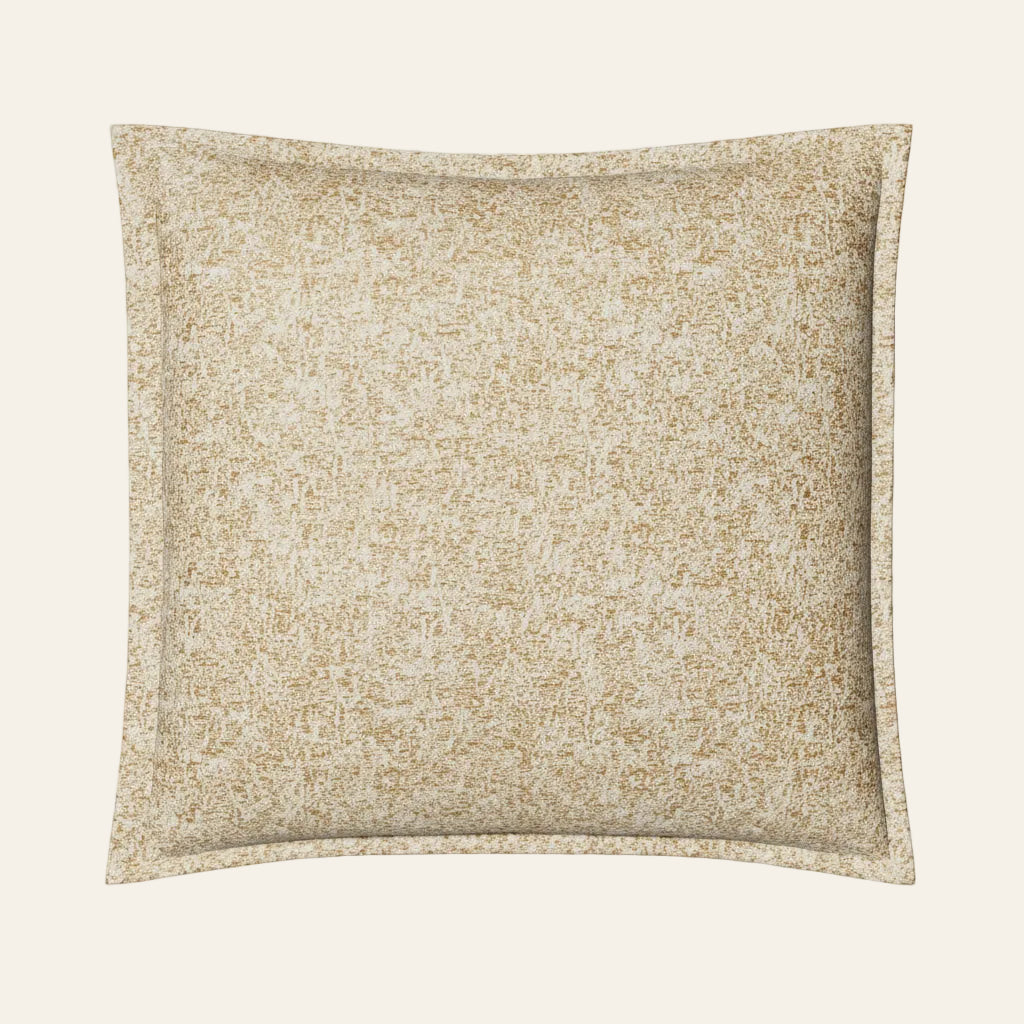 Ann Gish Glacier pillow in gold and ivory speckled texture with flanged border.