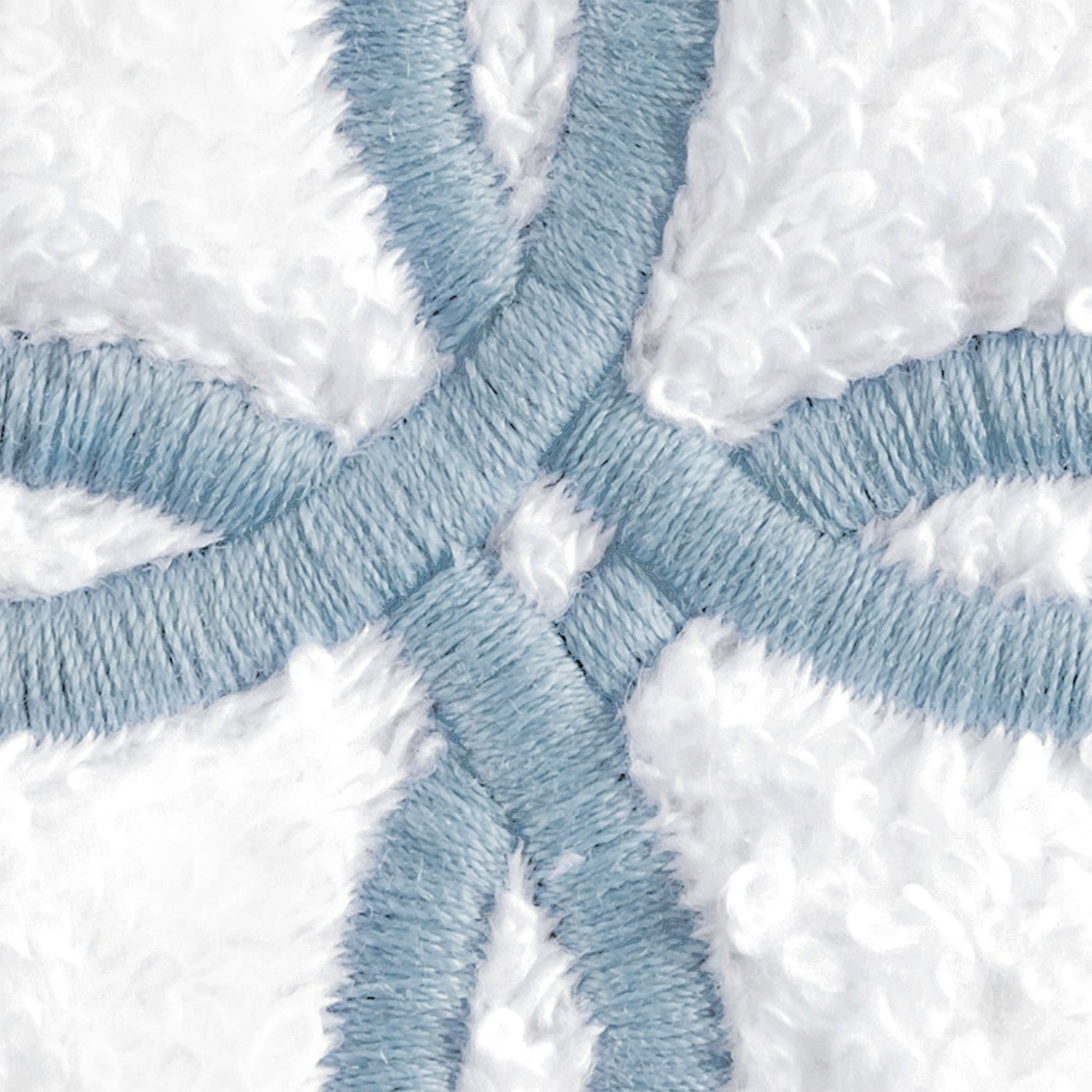 Close-up of powder blue embroidered Gordian knot detail on white terry cloth.