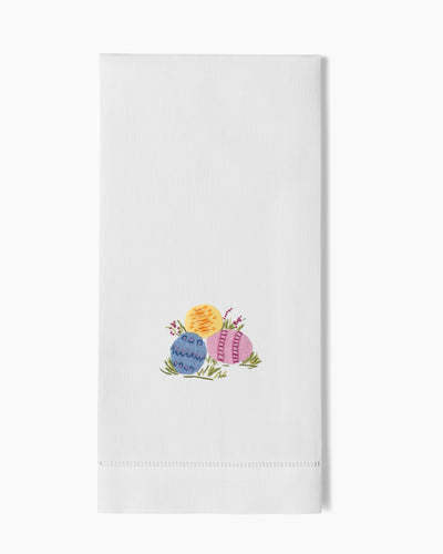 Henry Handwork white linen hand towel with embroidered Easter eggs in blue, yellow, and pink.