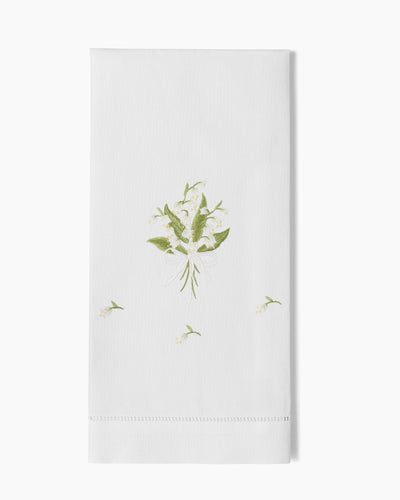 Henry Handwork Lily of the Valley hand towel in white linen with green floral embroidery.