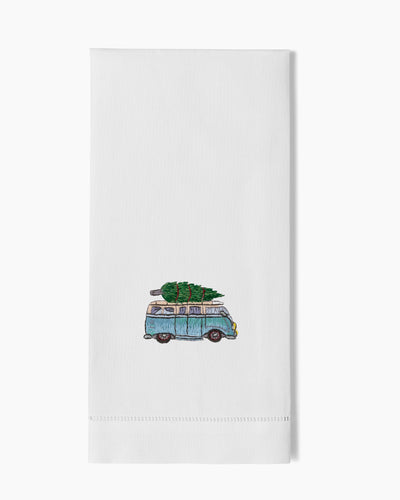 Henry Handwork white linen hand towel with embroidered blue VW bus carrying a Christmas tree.