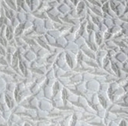 Close-up of ivory jacquard weave with raised floral and leaf pattern.
