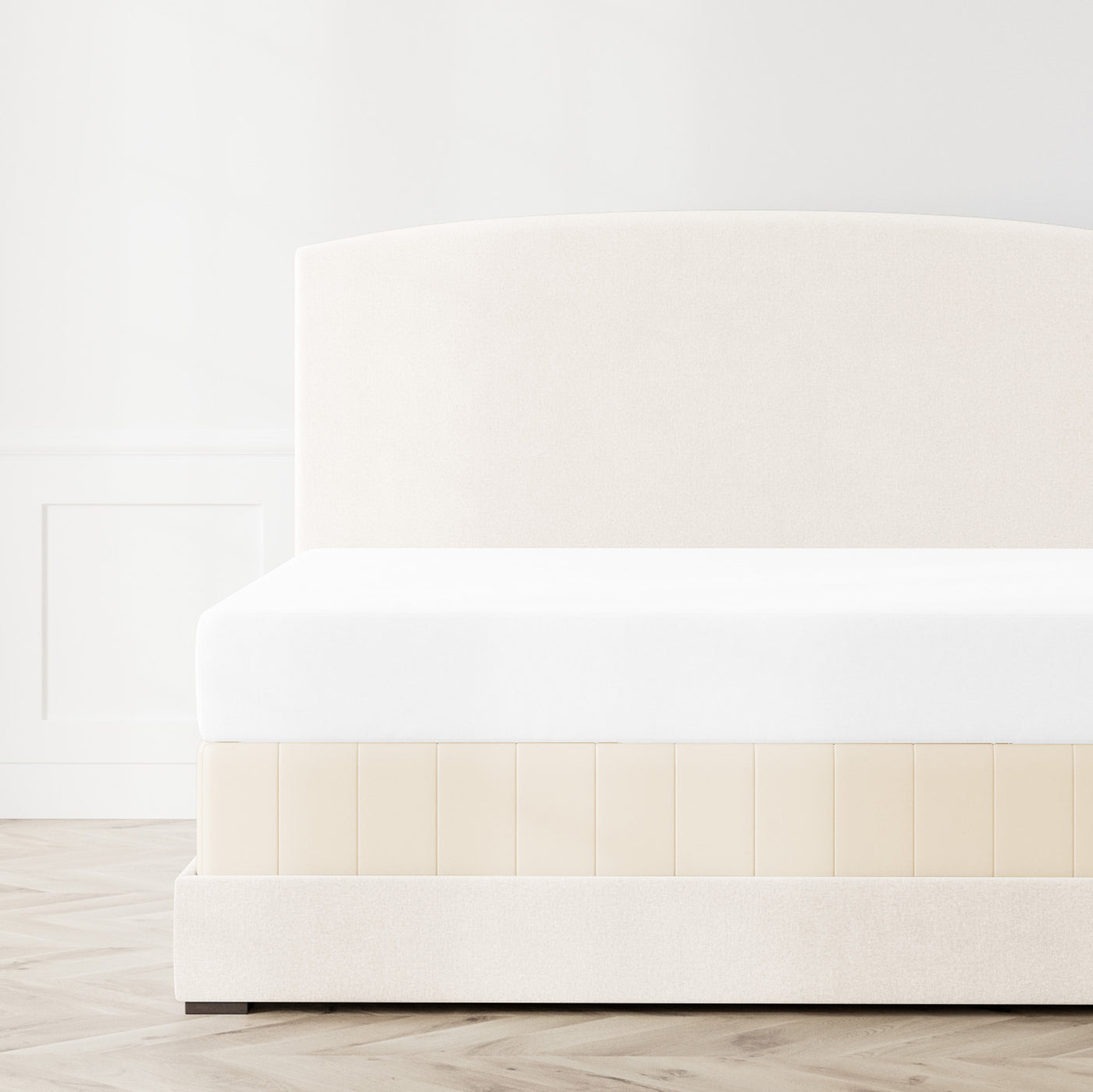 Ann Gish Hammered box spring cover in champagne with quilted vertical panels on styled bed.
