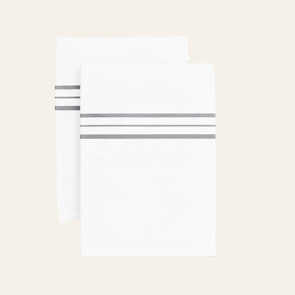 Ann Gish Hem Stripe pillowcases in white with grey triple-stripe hem detail, set of two.