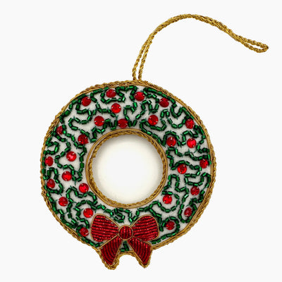 Henry Handwork beaded wreath ornament in green, red, and gold with bow accent.