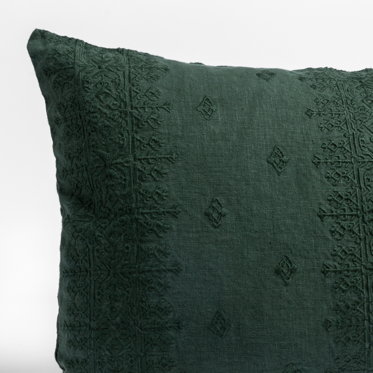 Close-up of Juniper Ines sham corner showing tonal embroidered diamond and geometric border detail.
