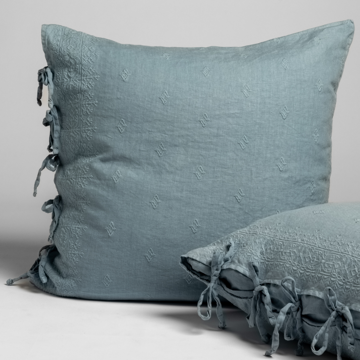 Bella Notte Ines sham in Tahoe Blue, showing side ties and tone-on-tone embroidery detail.