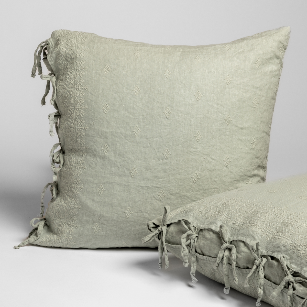 Side view of Bella Notte Ines sham in Eucalyptus, showing tied fringe detail along edge.