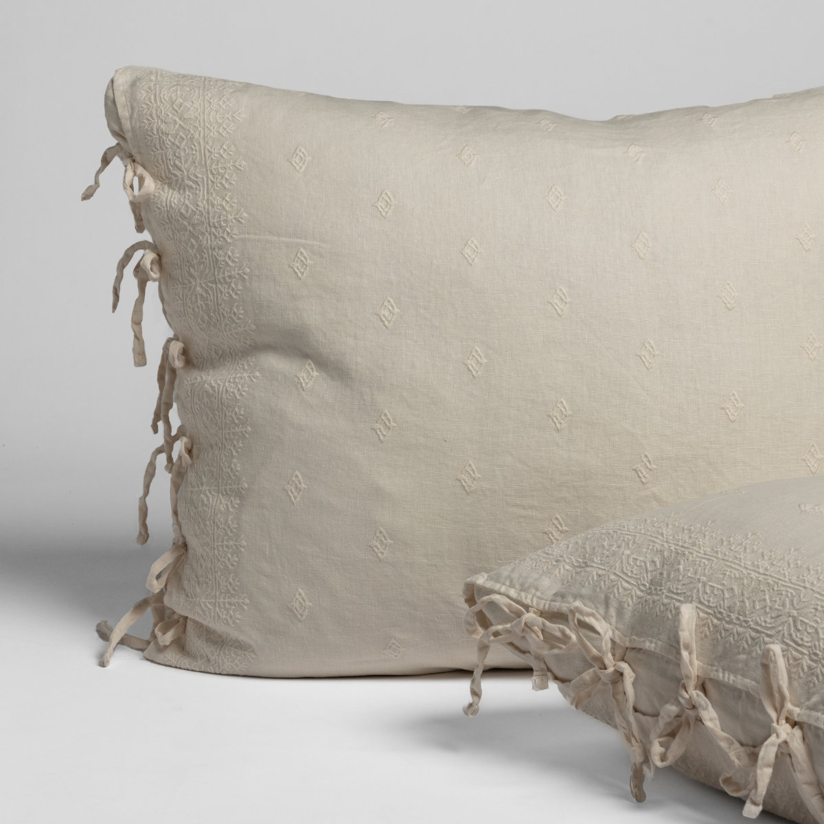 Bella Notte Ines sham in Natural, textured fabric with tied tassel side closures.