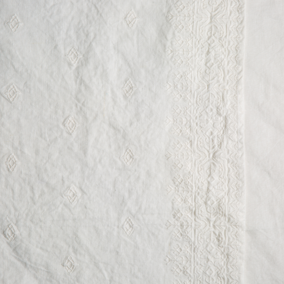 Close-up of Bella Notte Ines sham in Winter White, showing diamond jacquard and lace trim detail.