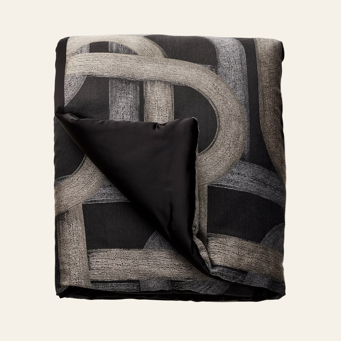 Ann Gish Interchange throw, folded, black with taupe geometric arc pattern, satin reverse.