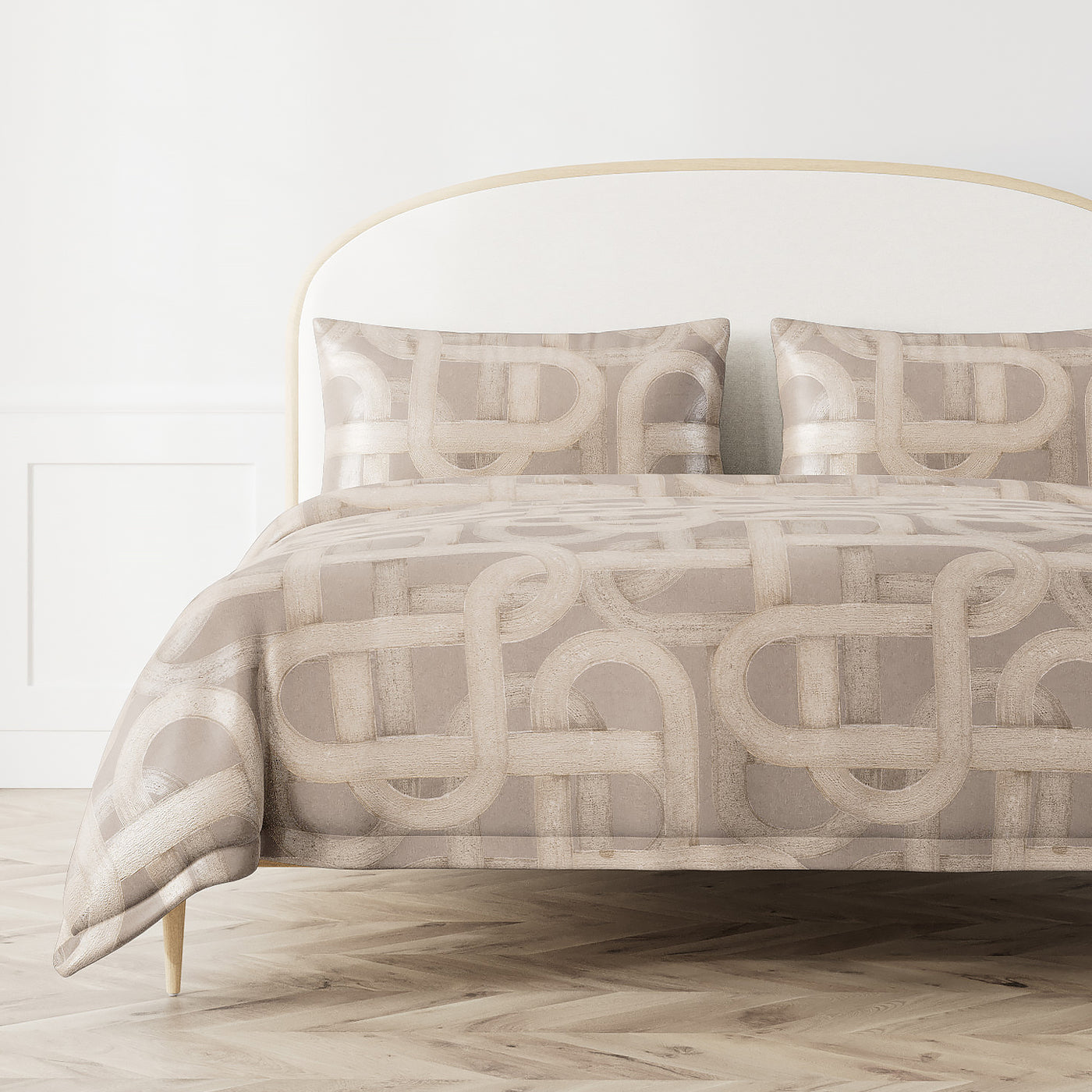 Taupe duvet cover with ivory interlocking geometric loop pattern, styled on a bed with matching shams.