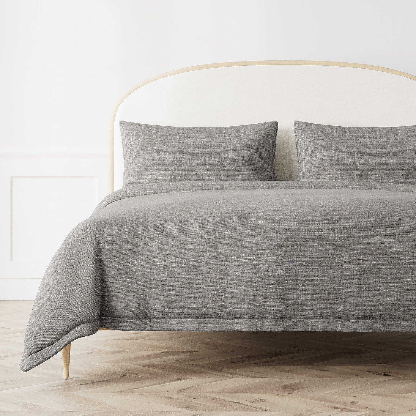 Heathered grey duvet cover with textured weave, styled on a bed with matching shams.